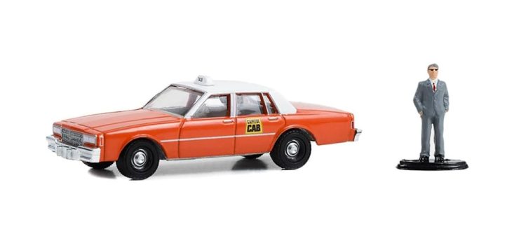 Greenlight - 1:64 The Hobby Shop Series 15 1981 Chevrolet Impala Capital Cab w/ Man in Suit